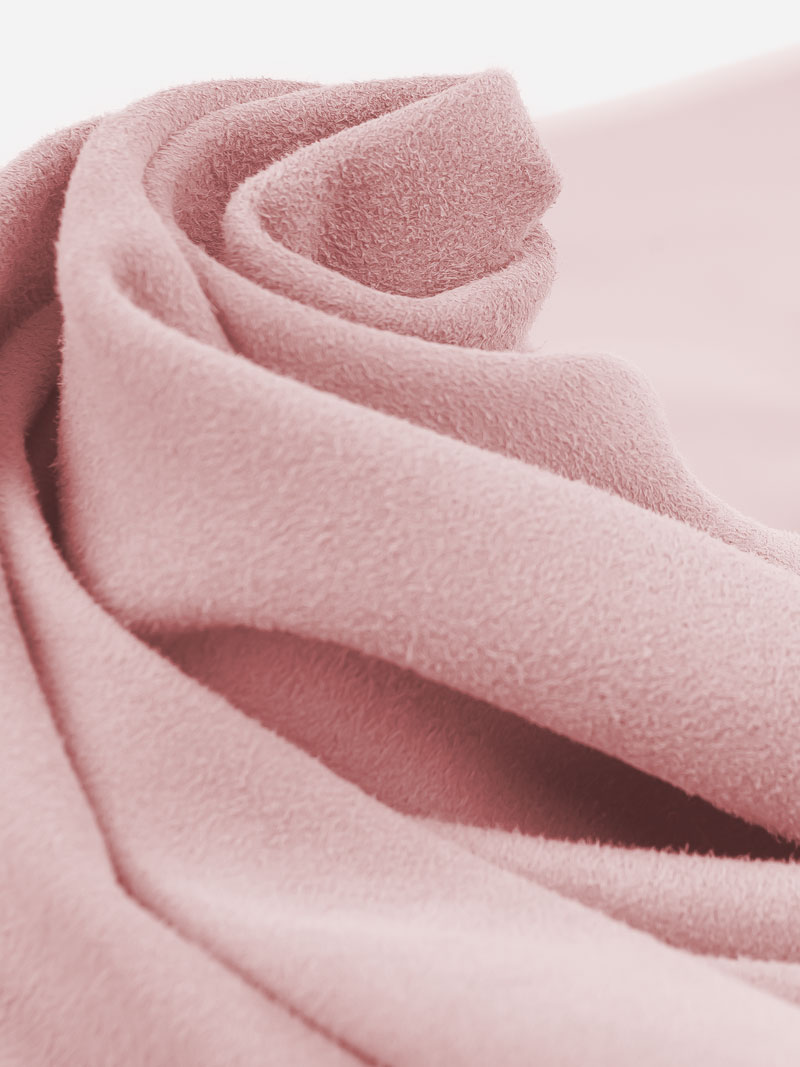 Leather pattern of a rose-coloured soft suede leather wrapped in folds in a circle