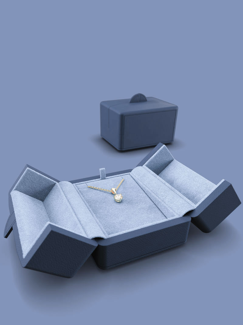 Fleur de Luxe open pendant jewellery case in the colour indigo, in the background a closed case